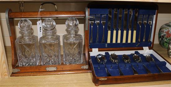 A three bottle oak tantalus and a small plated canteen.